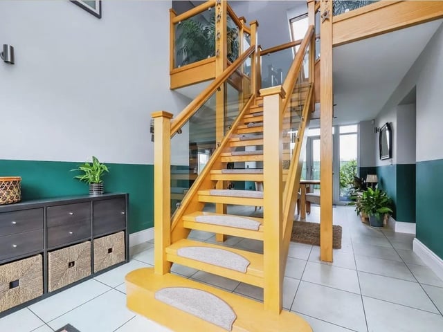 The stunning open entrance hall is flooded with light and enjoys the feature glass and oak staircase.