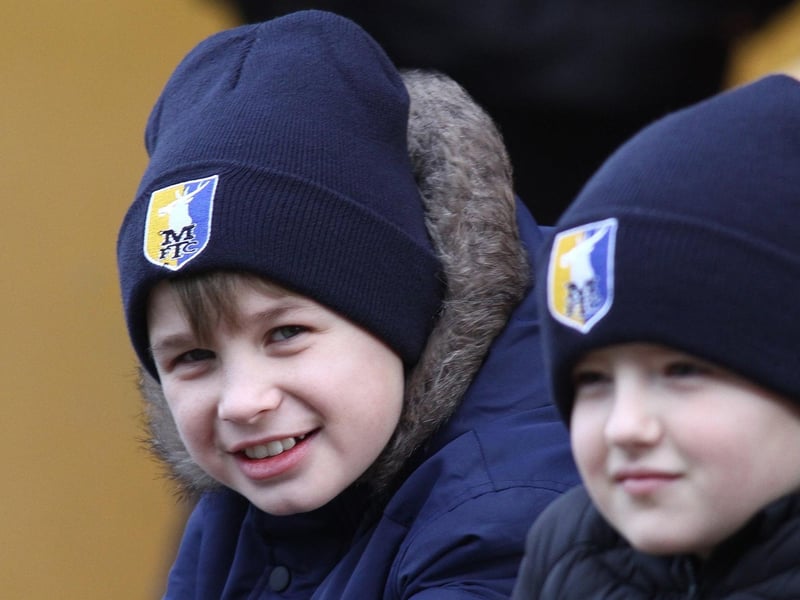 Thesse young fans watch Mansfield Town play Carlisle.