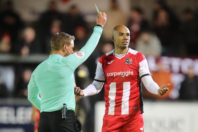 Jake Caprice of Exeter City is shown a yellow card.