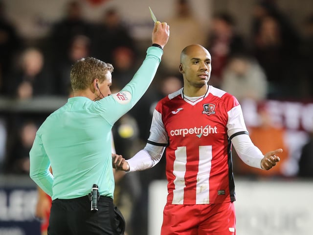Jake Caprice of Exeter City is shown a yellow card.