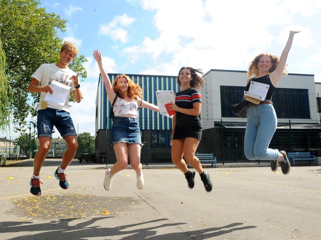 St Edmund's Catholic School students (l-r) Oliver Matthews (16), Grace Hargreaves (16), Louise Elliott (16) and Eloise Borrett (16), jump for joy with their results. Picture: Sarah Standing (200820-3040)