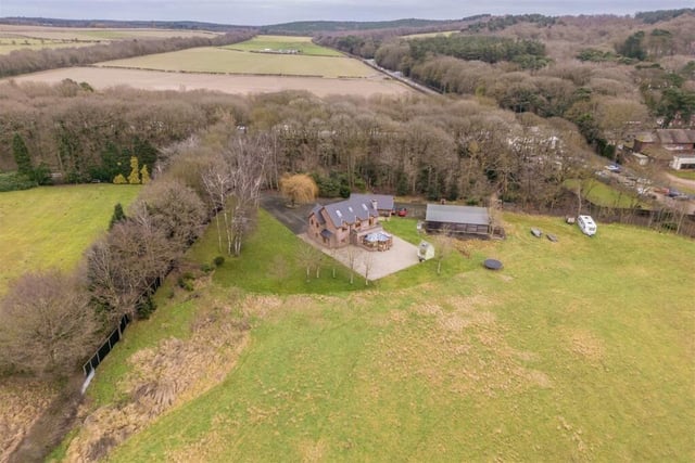 Before we step inside the property itself, this aerial shot gives a bird's eye view of the sprawling nine-acre estate it sits on. Woodland and meticulously landscaped gardens create endless possibilities for outdoor pursuits.