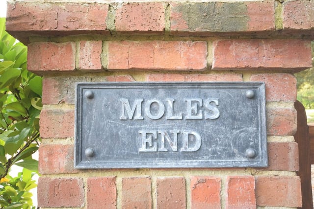 The sign that says it all at the electric gated entrance to Moles End. A large driveway leads you to the £925,000 property and its striking facade, complete with beautifully designed, covered porch.