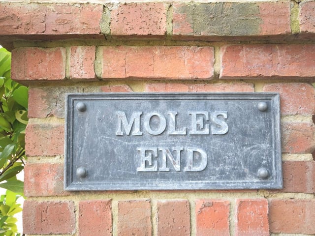 The sign that says it all at the electric gated entrance to Moles End. A large driveway leads you to the £925,000 property and its striking facade, complete with beautifully designed, covered porch.
