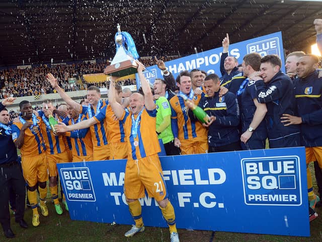 Captain Adam Murray lifts the championship trophy to mark Stags' return to the Football League.