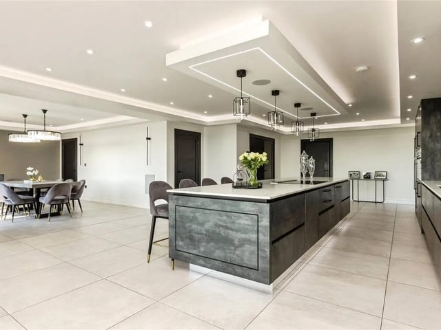 At its heart lies a breathtaking open-plan kitchen, expertly designed for both entertaining and everyday living that seamlessly flows into a spacious dining room and informal lounge area.