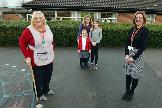 Brenda Needham midday supervisor at Crescent Primary School, Mansfield. She is 70 and hanging up her tabard after 38 years. Pictured: l-r Brenda Needham, Lisa Harris, Isabella Harris, Eleanor Harris and Headteacher Rachel Spray.