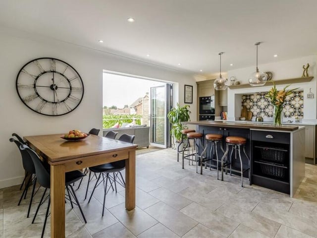 There is also plenty of room within the open-plan kitchen for a dining table. In the background, you can see the bi-fold doors that lead out to the balcony-patio