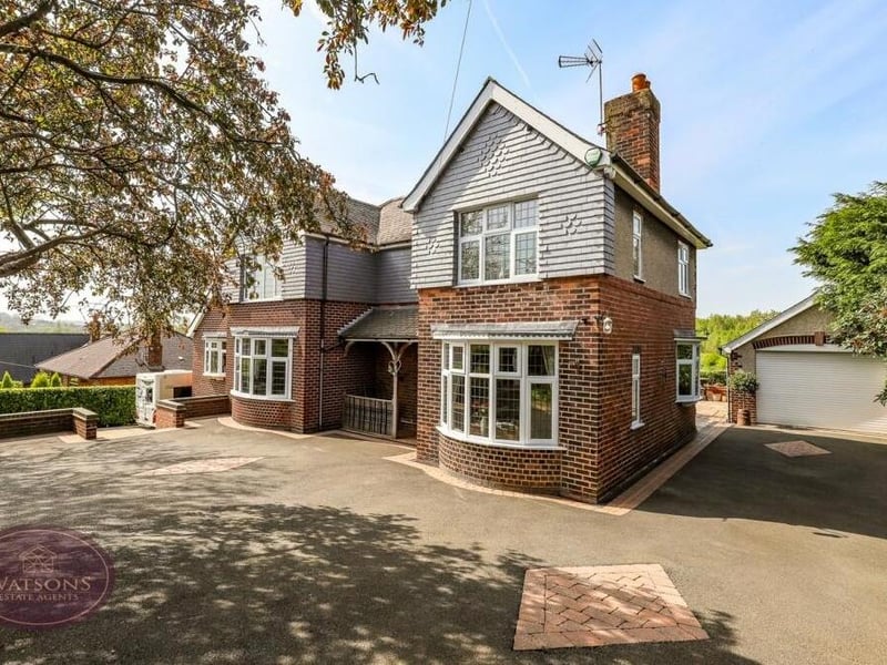 The final photo of our gallery shows how the driveway at the front of the house offers plenty of off-street parking space and leads to a detached garage, which has an electric roll-up door, power and a workshop at the back.