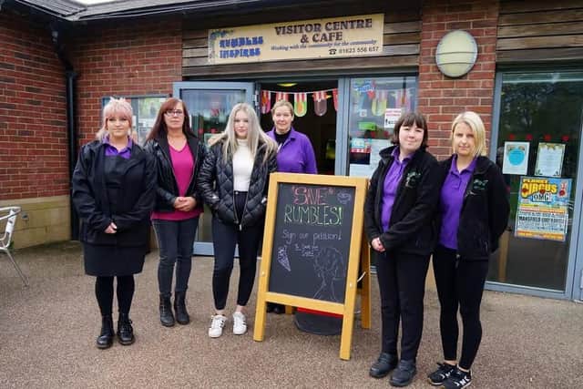 Staff with 'Save Rumbles' sign at Rumbles Community Cafe. (Photo: Brian Eyre/Mansfield Chad)