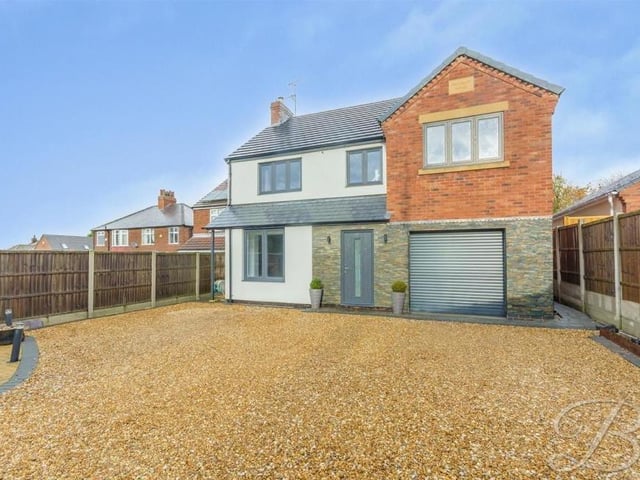 Returning outside now, and a closer look at the appealing frontage of the £575,000 house. You can see the spacious, gravelled driveway, where there is lots of room for off-street parking, and also the integral garage.