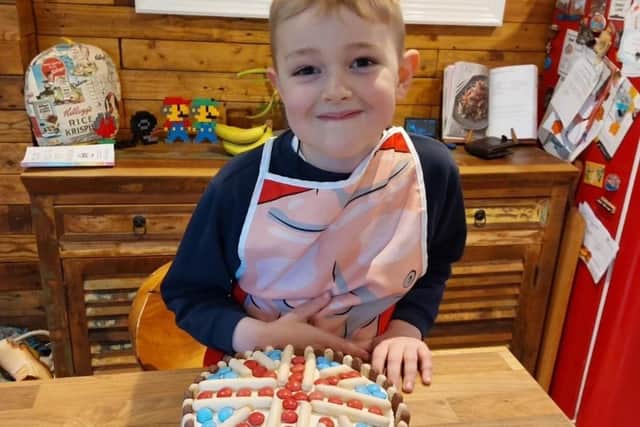 Freddie with his inventive chocolate finger cake creation.