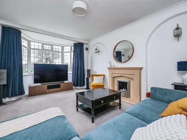 The lounge features a charming fireplace and lovely bay window