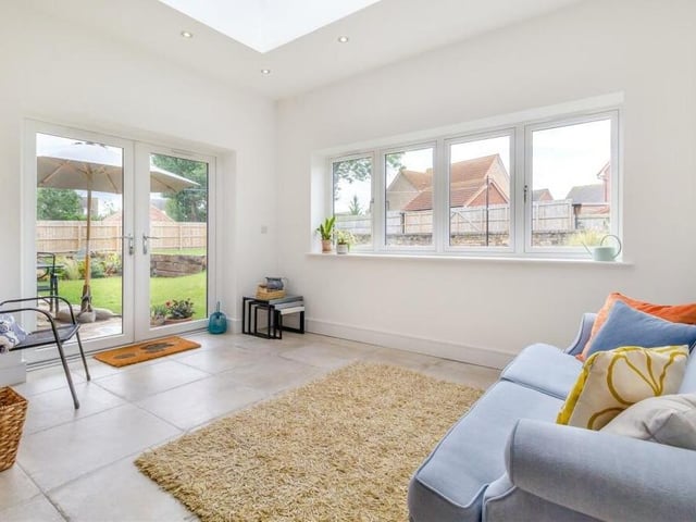 A second shot of the orangery extension, which boasts French doors leading out to the rear garden, ceiling spotlights and underfloor heating.