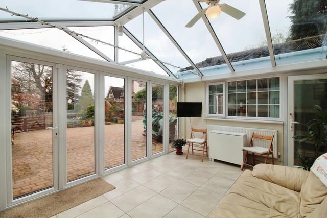 Moving on now to the charming conservatory that seamlessly extends the living space at Portland House. Large doors lead to the garden.