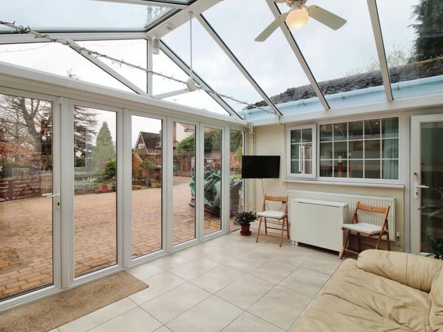 Moving on now to the charming conservatory that seamlessly extends the living space at Portland House. Large doors lead to the garden.