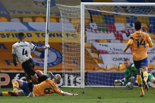 Newport's Joss Labadie scores the opening goal to punish Mansfield errors.
