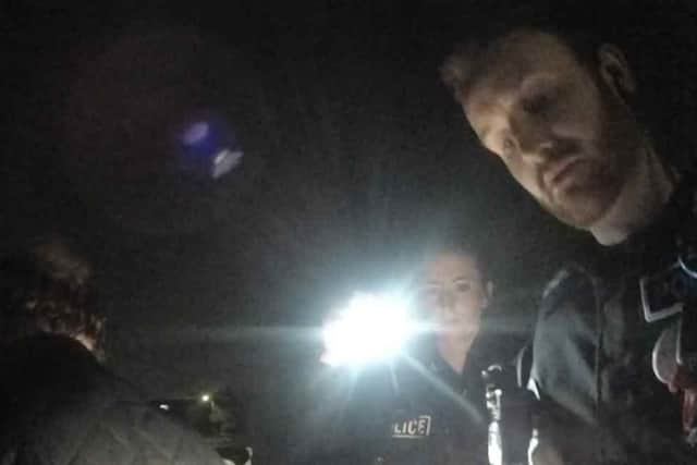 Mark Tems (left) being arrested by police