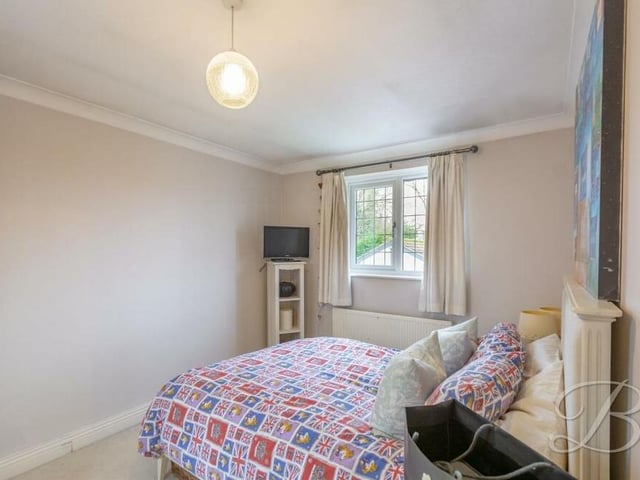 The second bedroom on the first floor of the house. It has a carpeted floor and overlooks the back garden.