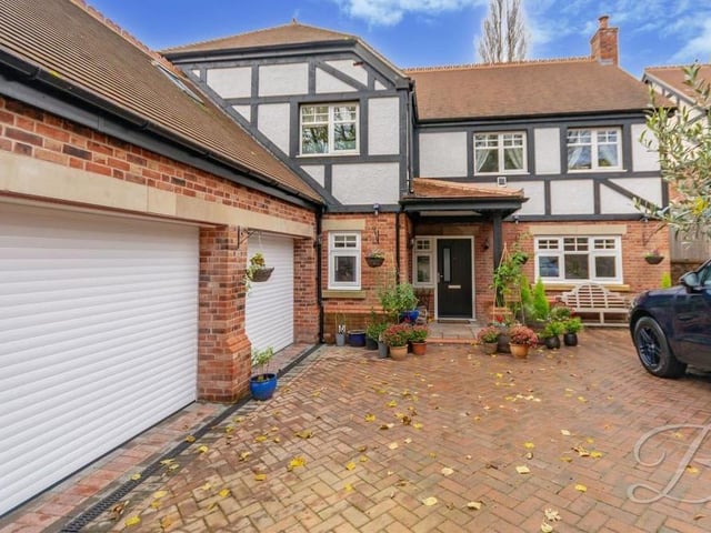 Our last photo returns to the front of the house, where a generously-sized, private driveway offers ample space for off-road parking, complemented by an integral double garage with electric doors, power and lighting. The garage can also be accessed from inside the property.