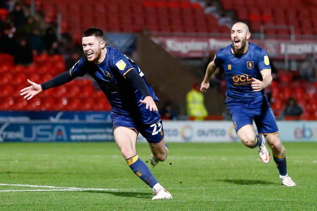 Mansfield Town loanee defender Will Forrester celebrates his FA Cup equaliser at Doncaster.