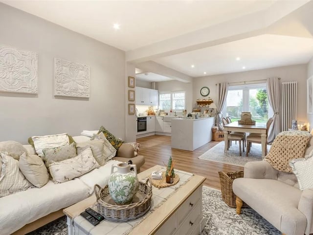 The living lounge area offers a fantastic space to enjoy family evenings, with featuring a built-in media wall with space for a television and sound bar below, plus built-in display shelving.