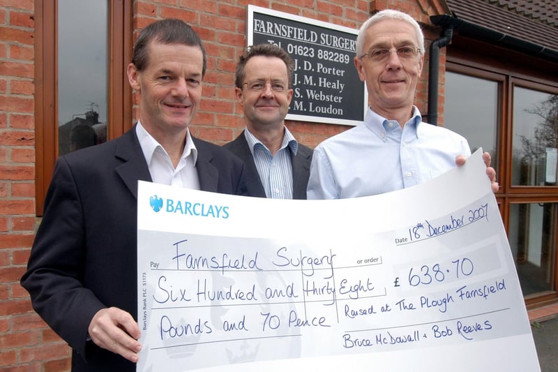 Bruce McDowall. right, presents a cheque for £636.70, the proceeds of a Beatles Quiz Night held at the Plough Inn in Farnsfield, to Drs Jim Healey and John Porter of Farnsfield Surgery.