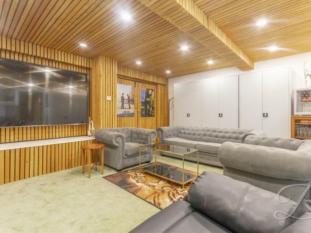 A garage has been converted into this superb, bright and spacious mutimedia room. It features raised flooring, fitted carpets, beautiful wooden walls and ceiling, hidden storage, downlights and numerous electric points.