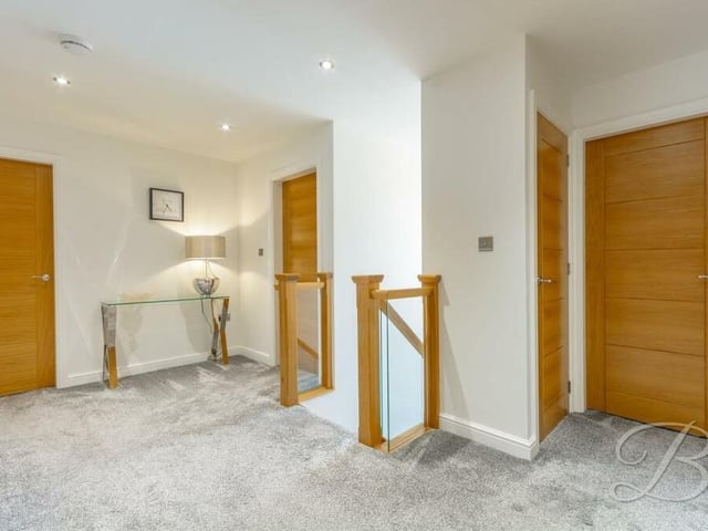 At the top of the stairs is this attractive first-floor landing. With fitted carpets, a storage cupboard and downlights, it gives access to all five bedrooms.