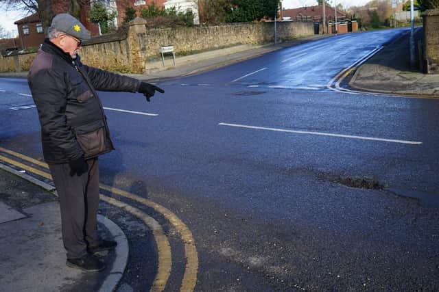 Sutton resident Mr Ian Kerry points out potholes on Skegby road.