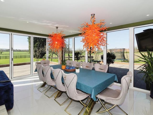 The dining room sits next to the sun room, offering the same brightness and views.