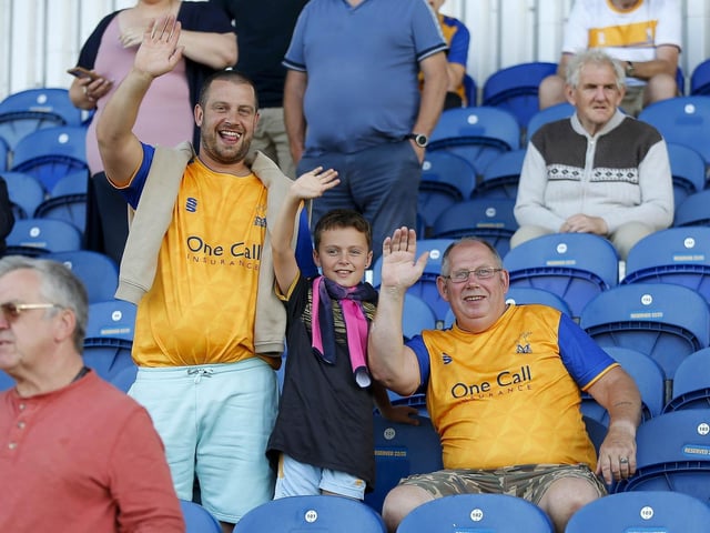 Mansfield Town fans watch the Carabao Cup first round match against Derby County.