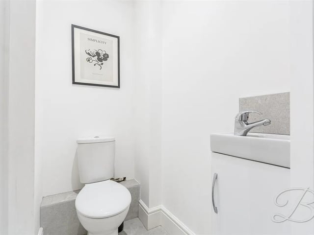 The property benefits from a downstairs toilet fitted with a low flush WC and hand wash basin.