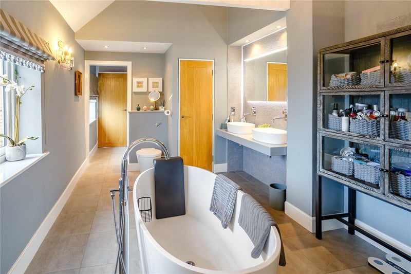 The large modern ensuite bathroom is fitted with a central free standing bath and serves both the principal bedroom and bedroom two.
