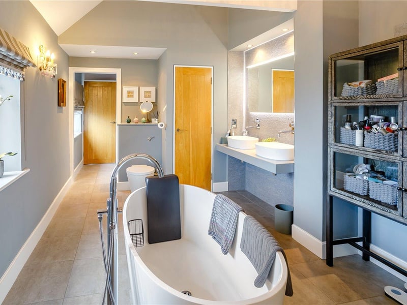 The large modern ensuite bathroom is fitted with a central free standing bath and serves both the principal bedroom and bedroom two.