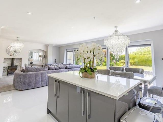 The sleek kitchen'diner, which is part of the open-plan hub at the £595,000 home, includes an island with extra cupboard space and also underfloor heating.