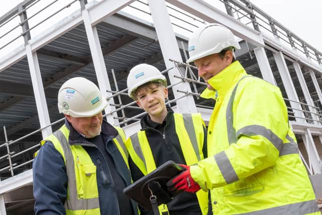 Clegg Construction project manager Andy Turner, left, and contracts manager Lyndon Bowler, right, with student Archie Martin