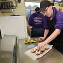 Samâ€™s Workplace, Rainworth are busy making Easter Egg cheesecakes, pictured is Graham putting the finishing touches to the cheesecakes