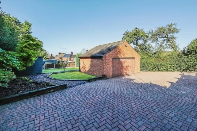 A private lane to the side of the front of the £580,000 Bagthorpe property leads to lots of off-street parking space and also this detached double garage.
