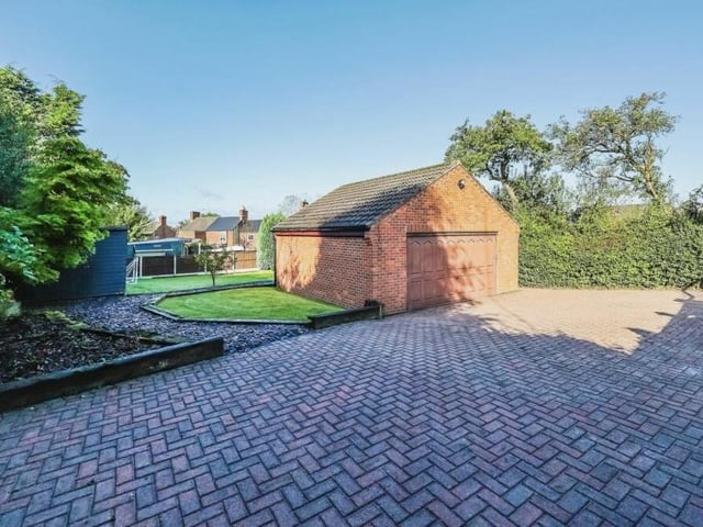 A private lane to the side of the front of the £580,000 Bagthorpe property leads to lots of off-street parking space and also this detached double garage.