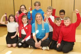 Rebecca Adlington and her Olympic medals with children from all the KS2 classes at Crescent Primary School.