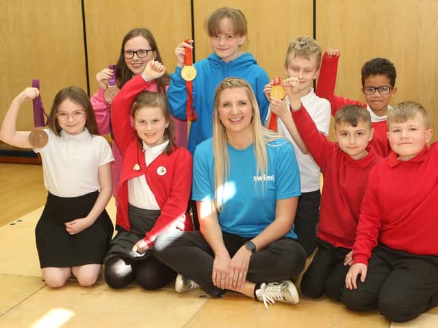 Rebecca Adlington and her Olympic medals with children from all the KS2 classes at Crescent Primary School.
