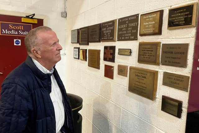 Tony by the memorial plaques to the 56 people who died in the tragedy. Photo: Submitted