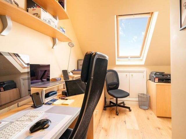 Let's take a look now at that converted loft. One half is dedicated to a cinema room, while this half has been turned into a well-equipped work-from-home office
