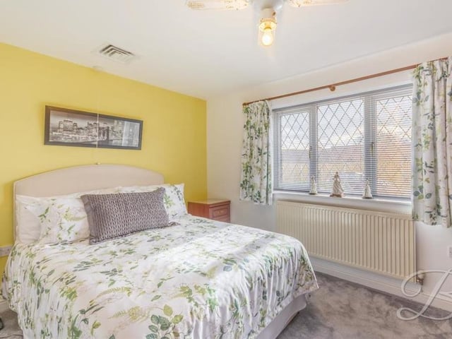 More bedroom comforts at Holly Drive. Extra warmth is provided by a carpeted floor and a central heating radiator.