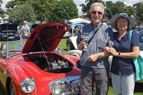 Pictured with one of his own classic cars and wife Sandra, retired engineer Pete Draycott, of Mansfield, who has organised the show in conjunction with the Nottingham Triumph Sports Six Club.
