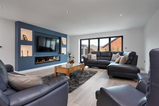 The substantial reception room having a wall feature with inset remote controlled electric fire, recess above with space to house a wall hung television. It also boasts bi-fold doors leading out onto the west facing rear garden.