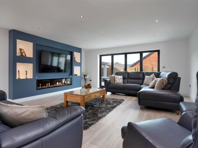The substantial reception room having a wall feature with inset remote controlled electric fire, recess above with space to house a wall hung television. It also boasts bi-fold doors leading out onto the west facing rear garden.