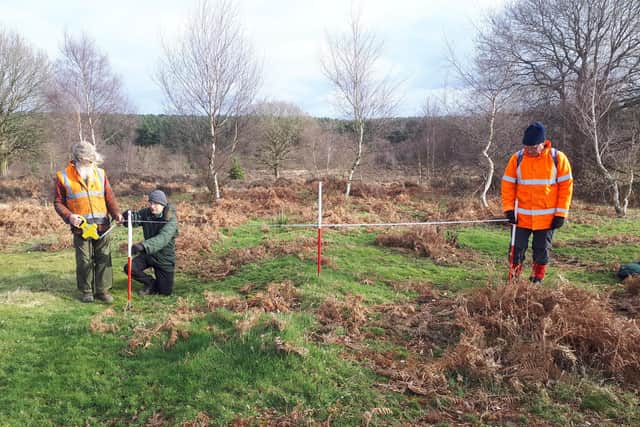 Project members measuring one of the areas being investigated for Second World War remains at Budby.