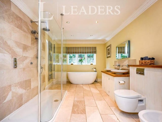 It's hard to envisage a better en suite that this excellent one to the master bedroom. A white suite comprises a walk-in double shower, free-standing bath, two wash hand basins, and a wall-hung, low-level WC urinal and bidet. Add to that underfloor heating, spotlights and a chrome, heated towel-rail